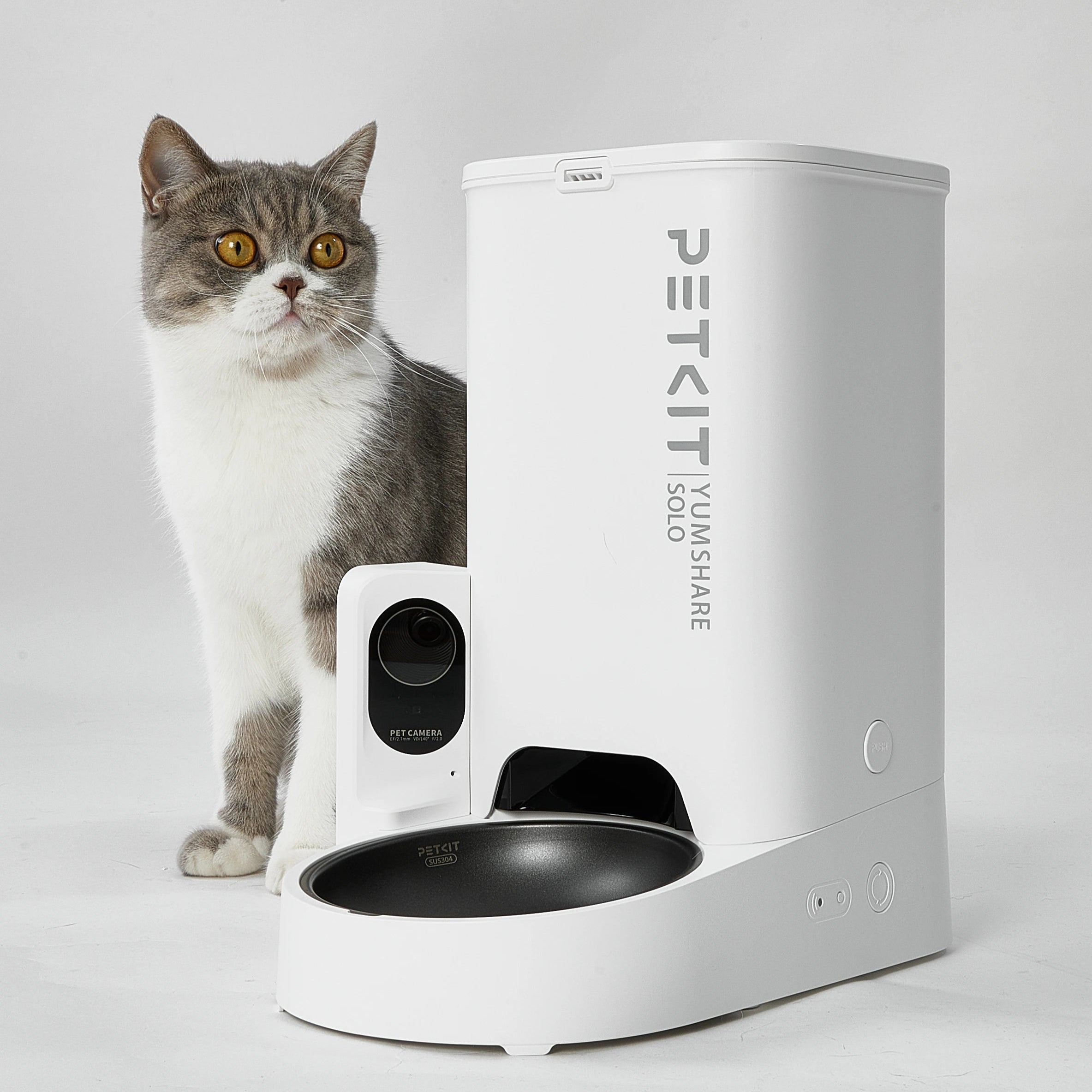 PetKit YumShare Solo pet feeder with a cat standing next to it on a white background
